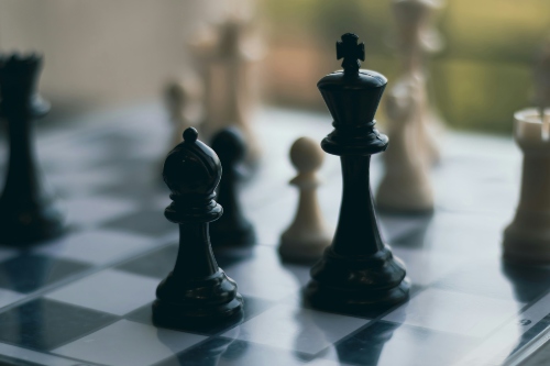 A runner and a king on a chess board.