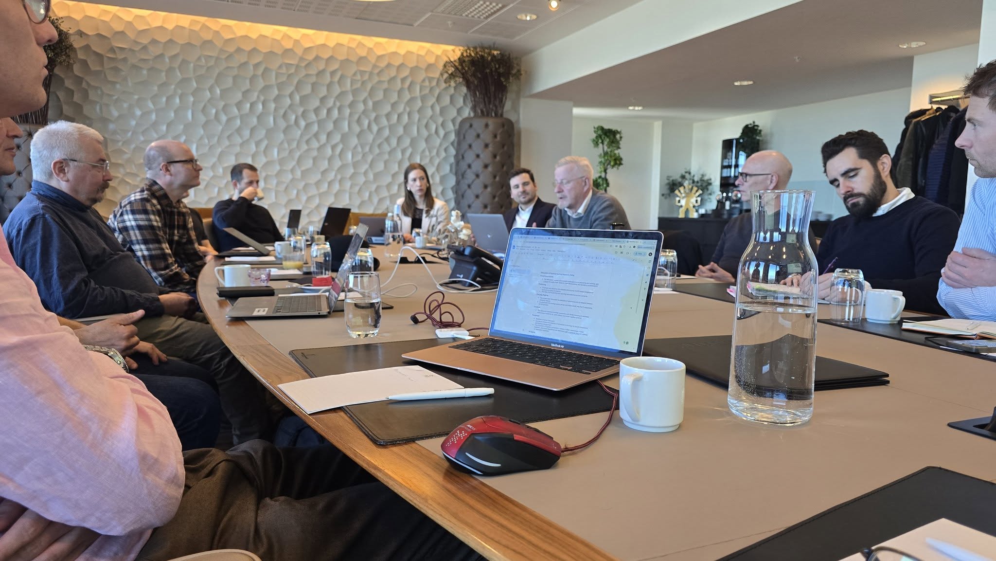 People round a table discussing Soscoe matters.
